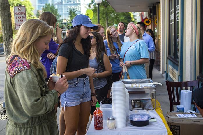 A crowd is shown outside ZMariks Noodle Cafe in Iowa City Wednesday, August 27, 2014. ZMariks among other restaurants  participated by offering samples of dishes in exchange for tickets that were purchased at separate booths. (The Daily Iowan/Sergio Flores)