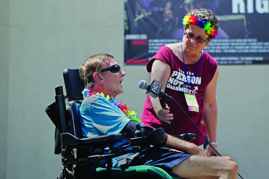 FILE - In this file photo, Keith Ruff talks at the Americans with Disability Act 25th Anniversary Celebration at the Ped Mall in Iowa City on Saturday July 25, 2015. The ADA is a civil rights law that bans discrimination against individuals with disabilities. (The Daily Iowan/Jai Yeon Lee, file)