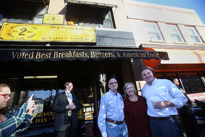 Hillary Rodham Clinton and U.S. Senate Candidate Bruce Braley pose with owner Dave Panther outside of Hamburg Inn No.2  on Wednesday, Oct. 29, 2014. This was the former U.S. Sectary of States first time at Hamburg Inn. (The Daily Iowan/Alyssa Hitchcock)
