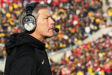 Iowa head coach Kirk Ferentz speaks into his headset during a timeout in Kinnick Stadium on Friday, November 28, 2014. Iowa was defeated by Nebraska in overtime, 37-34. (File Photo/The Daily Iowan)