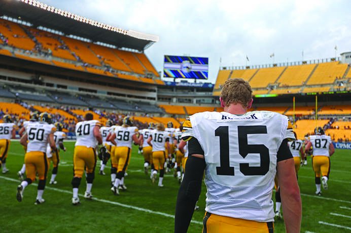 Iowa quarterback Jake Rudock leaves the field with his teammates after their 24-20 victory over Pitt at Heinz Field in Pittsburgh, Pennsylvania on Saturday, Sept. 20, 2014. Rudock threw for 80-yards on the game. (The Daily Iowan/Tessa Hursh)
