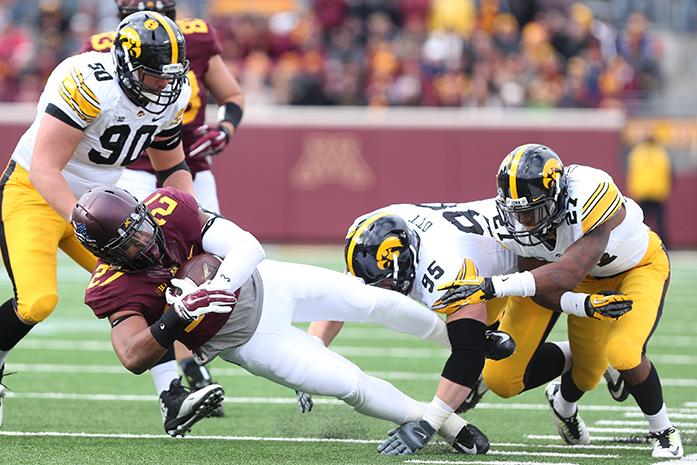 Minnesota+running+back+David+Cobb+dives+past+Iowa+defensive+linemen+Louis+Trinca-Pasat%2C+Drew+Ott+and+safety+Jordan+Lomax+for+a+first+down+in+TCF+Bank+Stadium+on+Saturday%2C+November+8%2C+2014+in+Minneapolis%2C+Minnesota.+Cobb+had+16+carries+for+74-yards+on+the+game.+The+Gophers+dominated+the+Hawkeyes%2C+51-14+to+reclaim+the+Floyd+of+Rosedale+trophy.+%28The+Daily+Iowan%2FTessa+Hursh%29