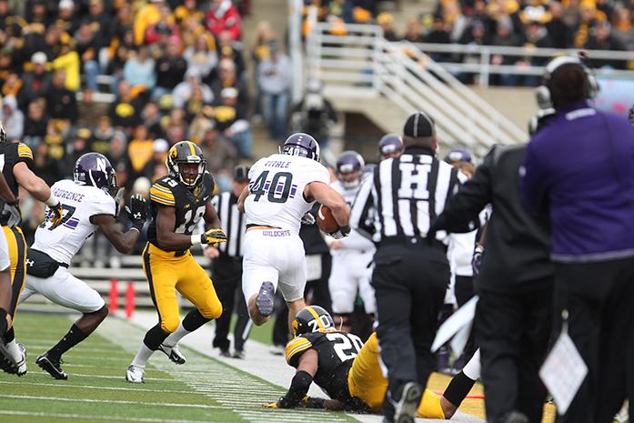 Northwestern+super+back+Dan+Vitale+breaks+a+tackled+from+Iowa+linebacker+Christian+Kirksey+as+he+runs+down+the+sideline+in+Kinnick+Stadium+on+Saturday%2C+Oct.+26%2C+2013.+Vitale+scored+Northwesterns+only+touchdown+of+the+game.+Iowa+defeated+Northwestern+in+overtime+17-10.+%28The+Daily+Iowan%2FEmily+Burds%29