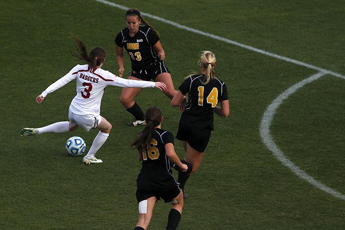 Wisconsin midfielder Rose Lavelle tries to evade the Iowa defense in the Big Ten soccer championship game at the Boilermaker Soccer Complex on Sunday, Nov. 9, 2014. The Badgers defeated the Hawkeyes in double overtime, 1-0. (The Daily Iowan/Joshua Housing)