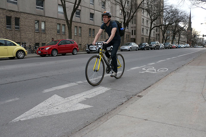 An Iowa City cyclist uses the bike lane on Jefferson Street on April 2. The UI Office of Sustainability has organized the Fall Bike Challenge to encourage people to ride bikes. (The Daily Iowan/File Photo)