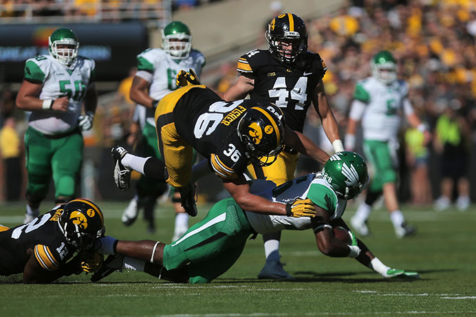 Iowa outside linbacker Cole Fisher tackles North Texas running back Jeffrey Wilson with the help from Iowa defensive back Anthony Gair during the Iowa-North Texas game in Kinnick Stadium on Saturday, Sept. 26, 2015. The Hawkeyes defeated the Mean Green, 62-16. (The Daily Iowan/Margaret Kispert)