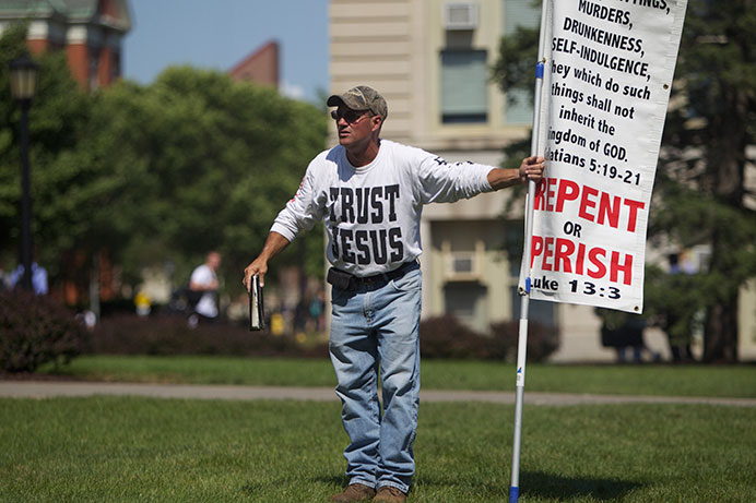 A protestor shouts at passersby on the Pentacrest on Tuesday, Sep. 15, 2015 at the University of Iowa. (The Daily Iowan/Brooklynn Kascel)
