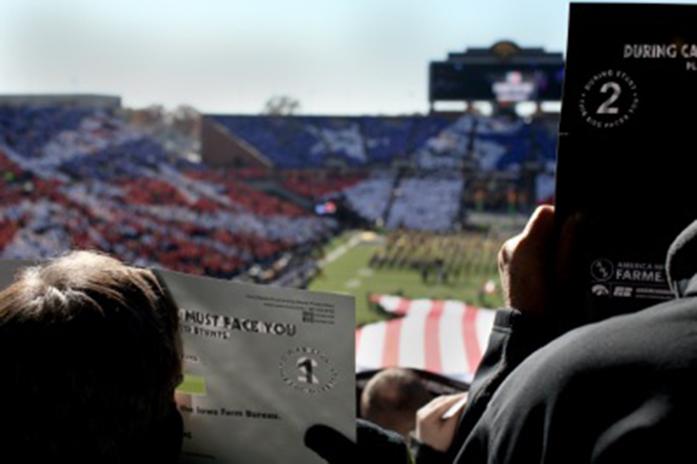 FILE - Fans hold up cards to their faces during the card stunt before the Iowa/Northwestern game in Kinnick Stadium on Saturday, Nov. 1, 2014. The card stunt was in dedication to veterans. The Hawkeyes defeated the Wildcats, 48-7. (The Daily Iowan/Alyssa Hitchcock, file)