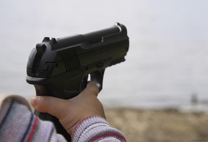The gun in the hands of child