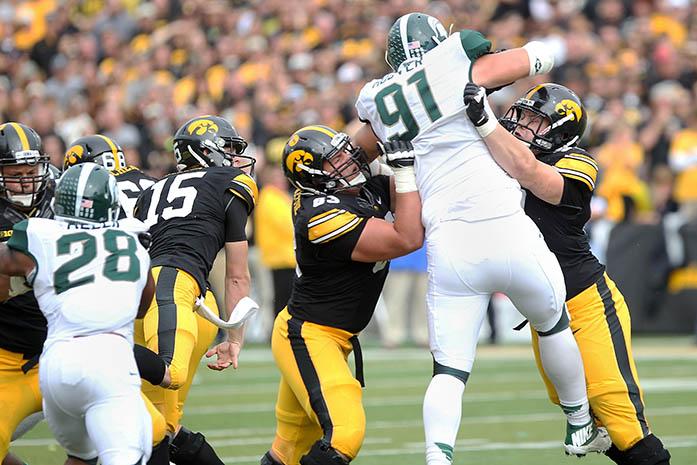 Iowa offensive lineman Austin Blythe and teammate block Michigan State defensive lineman Tyler Hoover in Kinnick Stadium on Saturday, Oct. 5, 2013. The Spartans defeated the Hawkeyes, 26-14. (The Daily Iowan/Tessa Hursh)
