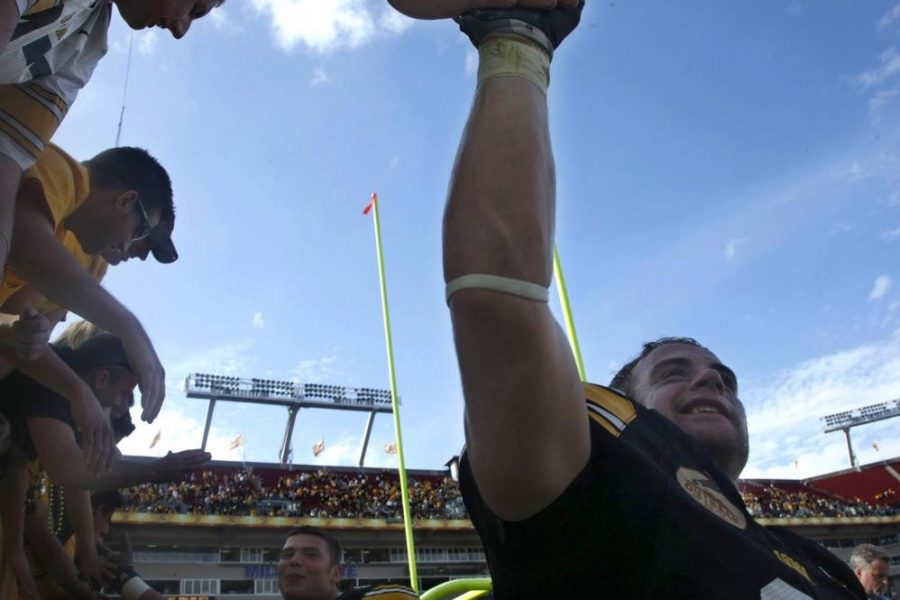 Lindsey Walters/The Daily Iowan
Tyler Sash shakes hands with Hawkeye fans after the Iowa Outback Bowl victory over South Carolina at Raymond James Stadium on Jan. 1, 2009.  Sash had two interceptions for 74 yards, setting an Iowa bowl record, and had four solo tackles.