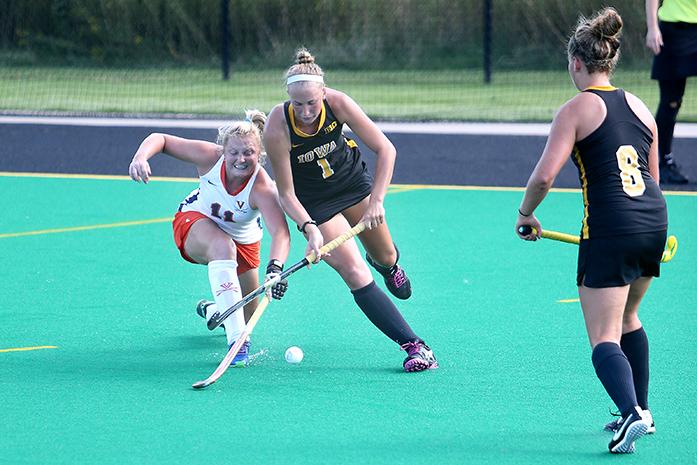 Iowa back Chandler Ackers and Virginia midfielder Lucy Hyams fight for the ball at Grant Field on Thursday, Sept. 4, 2014. The Hawkeyes beat the Cavaliers, 4-3. (The Daily Iowan/John Theulen)
