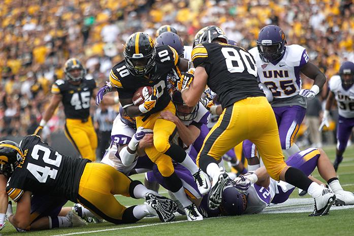 Iowa running back Jonathan Parker attempts to break through a tackle at the UNI game at Kinnick Stadium on Saturday, August 30, 2014. The Hawkeyes beat the Panthers 31-23. (The Daily Iowan/Margaret Kispert)