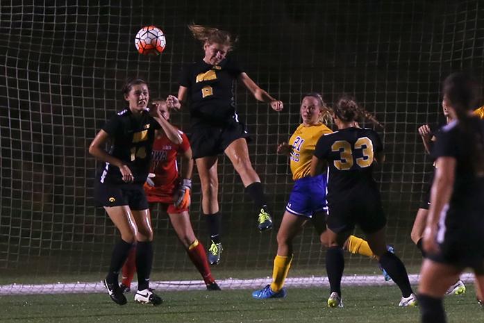 Iowa midfielder Jenna Kentgen head butts the ball during the SDSU-Iowa game at the Soccer Complex on Friday, August 28, 2015. Due to inclement weather the game was canceled after 20 mintues of game time with no score. (The Daily Iowan/Margaret Kispert)