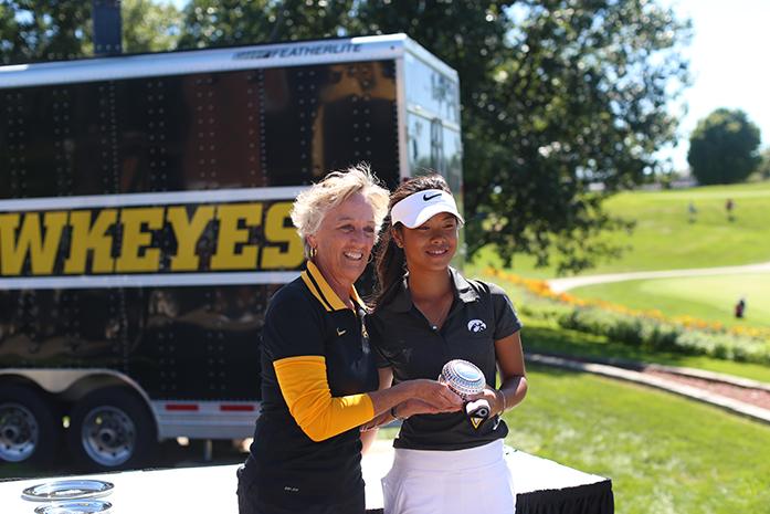 Diane Thomason hands Iowa golfer Jessica Ip her first place trophy after the Diane Thomason Invitational at Finkbine on Sunday, Sept. 13, 2015. The Hawkeyes finished a three-round with 888, 25-over par with Rutgers finished second 18 strokes behind Iowa. (The Daily Iowan/Margaret Kipsert)