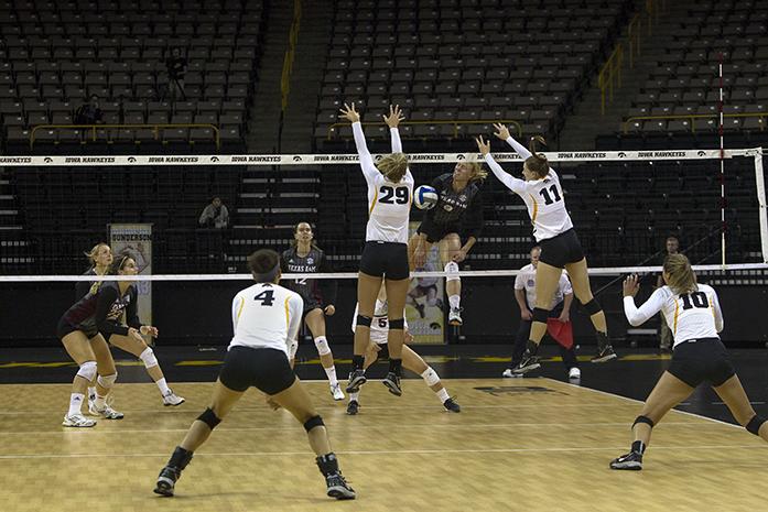 Iowa middle blocker Jess Janota (left) blocks the spike attack during the match against Texas A&M at the Carver- Hawkeye Arena on Saturday, September 12, 2015. The Hawkeyes defeated the Reveille, 3-1. (The Daily Iowan/Peter Kim)