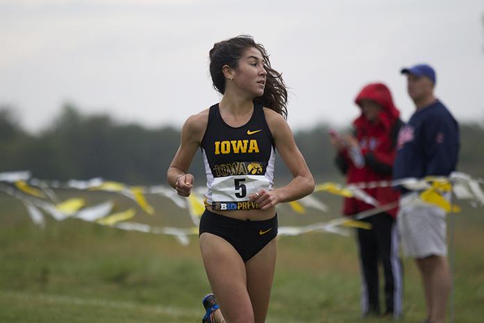 Iowa runner Marta Bote Gonzalez looks over her shoulder during the Big Ten Preview Womens 6k Race at Ashton Cross Country Course on Saturday, Sept. 20, 2014. Gonzalez finished with a time of 22:48.97 on the race. Iowa Men finished second and the Women finished fifth overall. Iowa Men finished second and the Women finished fifth overall. (The Daily Iowan/Alyssa Hitchcock)