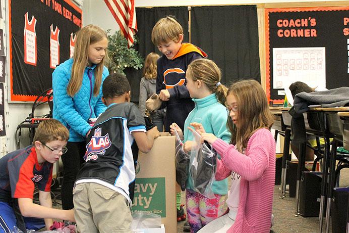 Longfellow Elementary collect items for the school’s annual coat drive, which collects coats and other winter-wear items for those who need them. (The Daily Iowan/McCall Radavich)