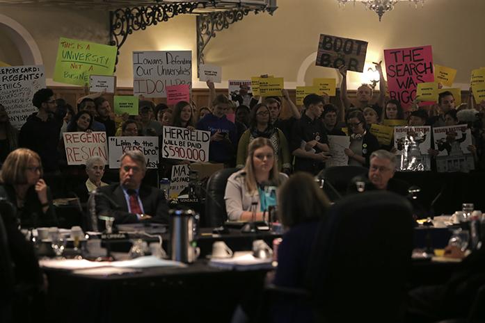 The Board of Regents is protested inside the main ballroom of the IMU on Wednesday, Oct. 21, 2015. Protestors demanded that the members of the Board of Regents resign. (The Daily Iowan/Mikaela Parrick)