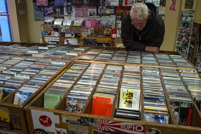 Iowa City resident Cliff Kinsel browses the CD collection at Record Collector on Wednesday, Oct. 28, 2015. Kinsel recently moved to Iowa City from Waterloo. (The Daily Iowan/Sergio Flores)