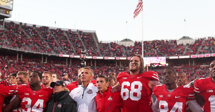 Ohio State players along with head coach Urban Meyer sing the school fight song at the end of the game at Ohio Stadium in Columbus, Ohio on Saturday, Oct. 19, 2013. Ohio State extended their winning streak to 19 games. Ohio State defeated Iowa, 34-24. (The Daily Iowan/Tessa Hursh)