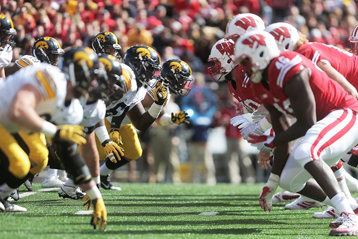 The Iowa offensive line and the Wisconsin defensive line go at eachother during the Iowa-Wisconsin game in Camp Randal Stadium on Saturday, Oct. 3, 2014. The Hawkeyes defeated the Badgers, 10-6. (The Daily Iowan/Margaret Kispert)