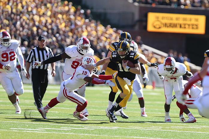 Iowa+quarterback+C.J.+Beathard+dodges+a+tackle+by+Indiana+safety+Tony+Fields+in+Kinnick+Stadium+on+Saturday%2C+Oct.+11%2C+2014.+Beathard+had+four+carries+for+28-yards+on+the+game.+Iowa+defeated+Indiana%2C+45-29.+%28The+Daily+Iowan%2FTessa+Hursh%29