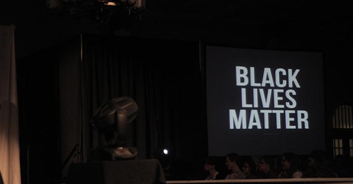The Black Lives Matter logo is shown at the Walk it Out fashion show in the IMU Main Lounge on Saturday, April 11, 2015. Walk it Out is a multicultural fashion show showcasing diversity within the university where portion of the sales goes to UIHC HIV/AID clinics. (The Daily Iowan/Courtney Hawkins)