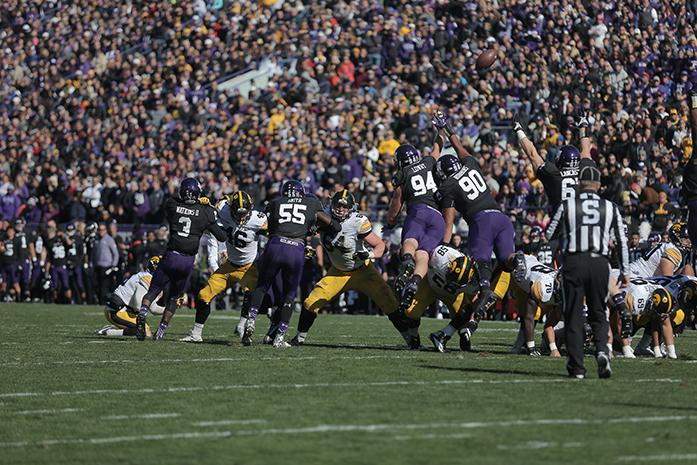 Northwestern defensive linemen Dean Lowry and C.J. Robbins attempt to block a field goal attempt by Iowa kicker Marshall Koehn during the Iowa-Northwestern game on Saturday, October 17, 2015. Koehn made two out of three field goals against Northwestern. The Hawkeyes defeated the Wildcats 40-10. (The Daily Iowan/Valerie Burke)