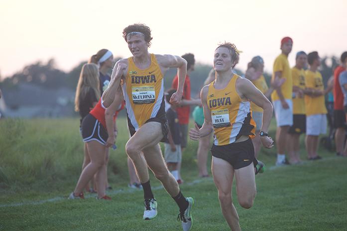Junior Sam McElhiney and Senior Daniel Huff battle towards the finish line during the mens 6k race on Friday, Sep. 4, 2015 at the Ashton Cross Country Course in Iowa City, Iowa. (The Daily Iowan/Brooklynn Kascel)