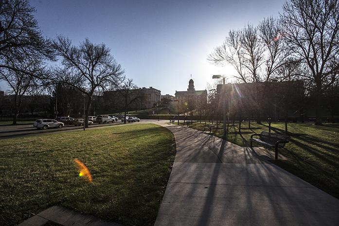 The sun rises behind the Old Capitol in Iowa City on Friday, April 10, 2015. Rand Paul was in town to drum up support after announcing his intention to run for president earlier this week.. (The Daily Iowan/Sergio Flores)