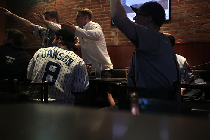 Cub fans react to a play of the third game of the Cub/Cardinals series at Airliner on Monday, Oct. 12, 2015. The Cubs are up 2-1 in the series. The forth game is at 3 pm Oct. 13. (The Daily Iowan/Margaret Kispert)