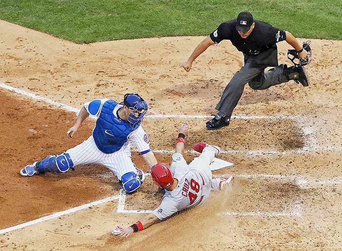 Chicago Cubs catcher Miguel Montero tags out St. Louis Cardinals Tony Cruz (48) during the sixth inning of Game 4 in baseballs National League Division Series, Tuesday, Oct. 13, 2015, in Chicago. Making the call is home plate umpire Mark Carlson. The Cubs won 6-4. (Chris Lee/St. Louis Post-Dispatch via AP)  EDWARDSVILLE INTELLIGENCER OUT; THE ALTON TELEGRAPH OUT; MANDATORY CREDIT