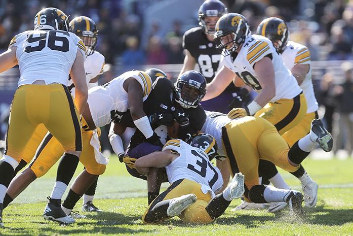 Northwestern running back Solomon Vault gets sacked by multiple Iowa players during the Iowa-Northwestern game on Saturday, October 17, 2015.  The Hawkeyes defeated the Wildcats 40-10. (The Daily Iowan/Valerie Burke)