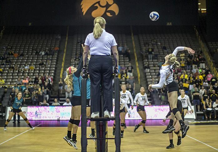 Hawkeye junior Lauren Brobst jumps in the air for a spike against Coastal Carolina on Friday, Sept. 18, 2015. Brobst had three spikes and 11 kills in the win over the Chanticleers. The Hawkeyes swept the Chanticleers 3-0. The Hawkeyes are undefeated so far this season at home at 7-0. (The Daily Iowan/Sergio Flores)