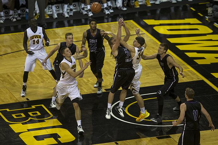 Iowa center Adam Woodbury tips the ball out of the paint against University of Sioux Falls in Carver-Hawkeye Arena on Thursday, Oct. 29, 2015. The Hawkeyes defeated the Cougars, 99-73. (The Daily Iowan/Joshua Housing)