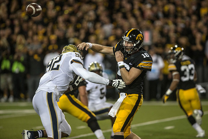 Hawkeye quarterback C.J. Beathard passes under pressure from Pittsburgh's Rori Biair on Sept. 19 in Kinnick. Beathard was only sacked once during the game, and the Hawkeyes defeated the Panthers, 27-24, on a last-second field goal. (The Daily Iowan/Sergio Flores)