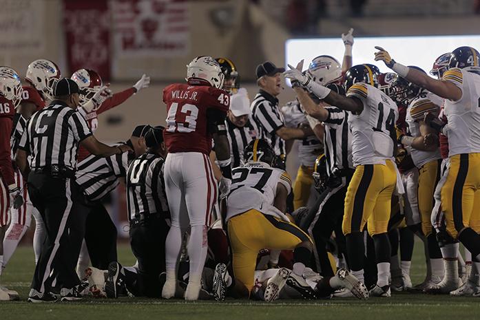 Indiana and Iowa players argue over a fumble recovery from an on side kick during the Iowa-Indiana game in Memorial Stadium in Bloomington on Saturday, Nov. 7, 2015. The Hawkeyes stay undefeated after beating the Hoosiers, 35-27. (The Daily Iowan/Margaret Kipsert)