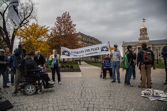 Residents gather in front of the Old Capitol to show their support for Armistice Day. The Veterans for Peace Chapter 161 held an event for observance of Armistice Day on the Pentacrest at the University of Iowa, in Iowa City on Nov. 11(The Daily Iowan/Anthony Vazquez)