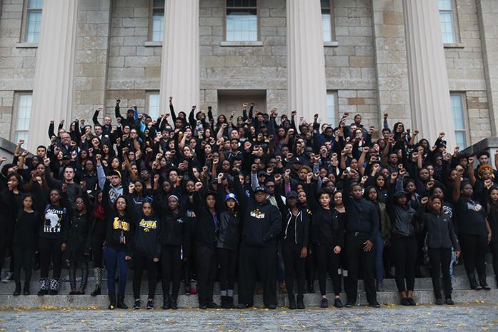 UI+students+stand+together+for+a+group+photo+on+the+steps+of+the+Old+Capitol+building+during+a+protest+in+solidarity+in+Iowa+City+on+Wednesday.+Students+gathered+in+reaction+to+alleged+racially+driven+incidents+on+the+University+of+Mizzous+campus.+%28The+Daily+Iowan%2FBrooklynn+Kascel%29