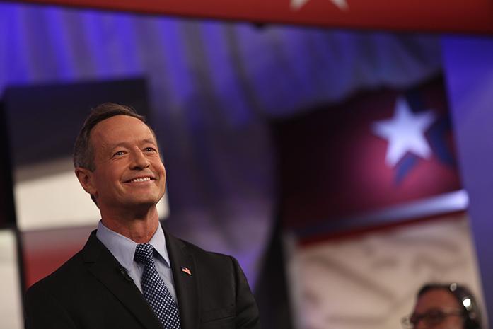 Democratic presidential candidate Martin O'Malley smiles at the audience during the photo spray before the start of the Democratic debate on Saturday, Nov. 14. The debate took place in Carnegie Hall on Drake University's campus. (The Daily Iowan/Brooklynn Kascel)