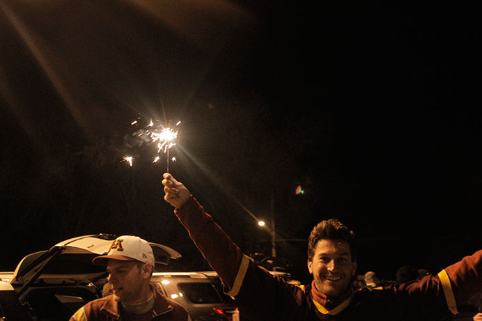 A Minnesota Gopher fan is shown waving a sparkler at a tailgate before the Iowa vs. Minnesota game on Saturday, Nov. 13, 2015. The Hawkeyes beat the Gophers, 40-35, creating a new record with a 10-0 winning streak. (The Daily Iowan/Courtney Hawkins)