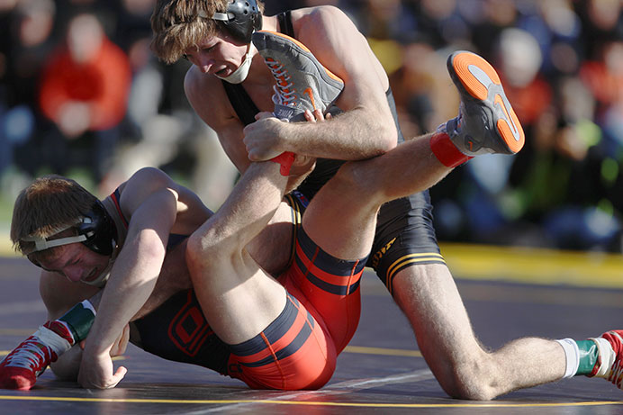 Iowa's Cory Clark wrestles against Oklahoma State's Gary Wayne Harding in the 133-pound match in Kinnick Stadium on Saturday, Nov. 14. Clark defeated Harding by decision, 8-2. The Hawkeyes defeated the Cowboys, 18-16. (The Daily Iowan/Joshua Housing)