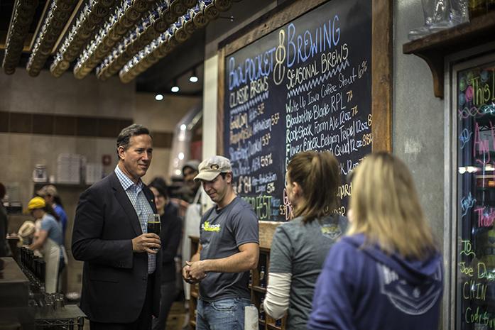 Rick+Santorum+stands+behind+the+bar+of+Back+Pocket+Brewery+on+Nov.+18%2C+2015.+Santorum+visited+the+brewery+in+hopes+of+drumming+up+support+for+his+presidential+campaign.+%28The+Daily+Iowan%2FSergio+Flores%29
