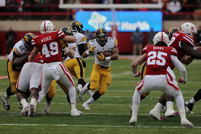 Iowa running back Jordan Canzeri finds a hole in the line during the Iowa-Nebraska game at Memorial Stadium on Friday, Nov. 27. The Hawkeyes defeated the Cornhuskers, 28-20, to finish off a perfect regular season. (The Daily Iowan/ John Theulen)