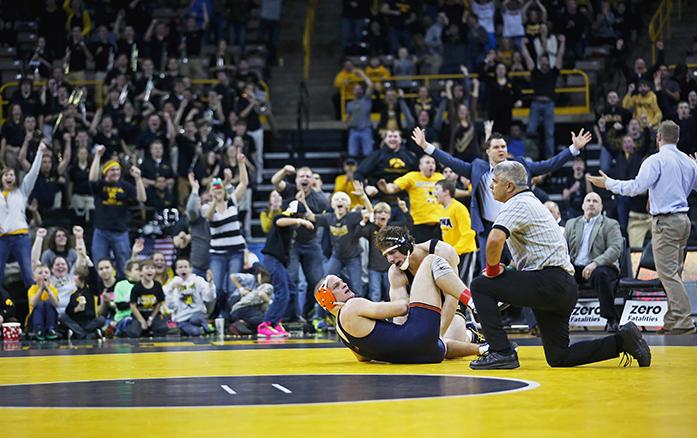 Illinois 174-pounder Zac Bruson and Iowas Alex Meyer react to the last second pin during the Iowa-Illinois duel in Carver-Hawkeye Arena on Friday, Jan. 16, 2015. Meyer pinned Brunson in 6:59. The Hawkeyes defeated the Fighting Illini, 25-12. (The Daily Iowan/Margaret Kispert)