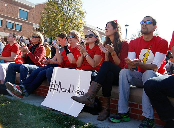 University of Missouri students clap while the co-chair of the Forum on Graduate Rights introduces speakers during a rally for graduate student rights at Traditions Plaza at the University of Missouri campus on Tuesday, Nov. 10, 2015, in Columbia, Mo. The speakers expressed support of the group Concerned Student 1950. (Sarah Bell/Missourian via AP) MANDATORY CREDIT, MAGS OUT