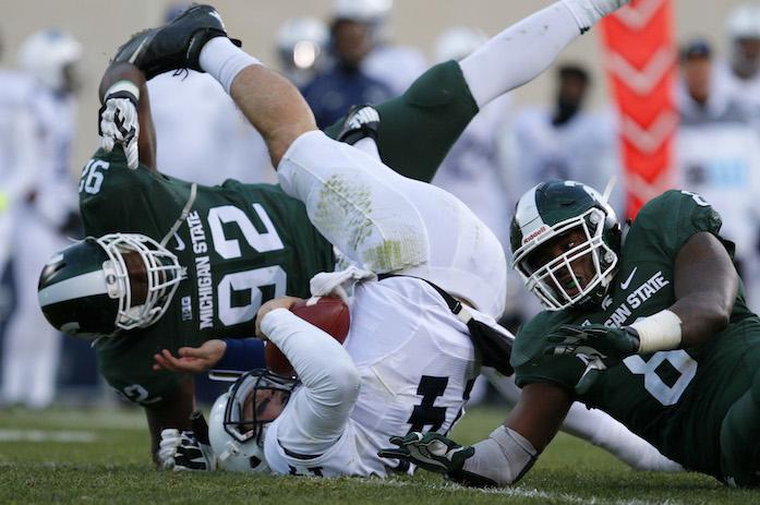 Penn State quarterback Christian Hackenberg, center, is sacked by Michigan State's Joel Heath (92) and Lawrence Thomas, right, during the second quarter of an NCAA college football game, Saturday, Nov. 28, 2015, in East Lansing, Mich. (AP Photo/Al Goldis)