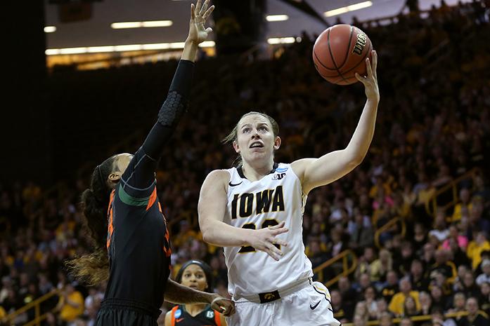 Iowa guard Samantha Logic goes up for a layup against Miami guard Suriya McGuire during the second round game of the NCAA womens basketball tournament in Carver-Hawkeye Arena on Sunday, March 22, 2015. The Hawkeyes defeated the Hurricanes, 88-70 advancing to Sweet Sixteen in Oklahoma City . (The Daily Iowan/Margaret Kispert)