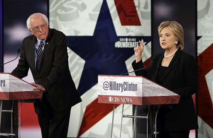 In this Nov. 14, 2015, photo, Hillary Rodham Clinton, right, makes a point as Bernie Sanders listens during a Democratic presidential primary debate in Des Moines, Iowa. Clinton and Sanders are outlining the steps on Nov. 19, they would take to combat the Islamic State group, each making major speeches less than a week after the deadly attacks in Paris. (AP Photo/Charlie Neibergall)